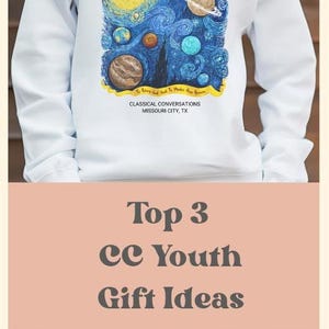 May include: A long-sleeve sweatshirt featuring a graphic of swirling blue space with planets and a yellow banner containing the text "To Know God And To Make Him Known" and "CLASSICAL CONVERSATIONS MISSOURI CITY, TX" printed in black, white, or maroon.