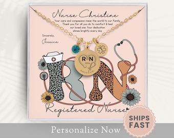 May include: A pink and white gift box with a gold necklace inside. The necklace has a charm that says "RN" and a stethoscope charm. The box also has the text "Nurse Christine" and "Registered Nurse".