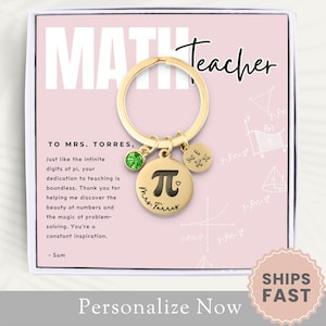 May include: A gold-colored keychain with a charm that says "Math Teacher" and a charm with the Greek letter pi. The keychain is in a white box with a pink background and the text "To Mrs. Torres, Just like the infinite digits of pi, your dedication to teaching is boundless. Thank you for helping me discover the beauty of numbers and the magic of problem-solving. You're a constant inspiration. -Sam"