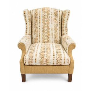 May include: A wingback armchair featuring a cream-coloured fabric upholstery with vertical stripes of brown and tan zigzag patterns. The chair has rolled arms, a high backrest, and a solid tan fabric base supported by four dark wooden legs.