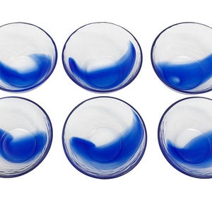 May include: Six clear glass bowls with a blue wave design. The bowls are arranged in two rows of three, each with a textured exterior and a vibrant blue accent that creates a flowing, artistic effect.