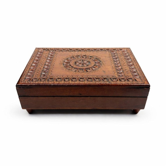 A hand-carved Polish wooden music box with a lidded trinket compartment — old-world craftsmanship you genuinely can't find at Target.