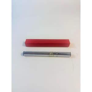 May include: A silver-colored, cylindrical object with black ends and a small label, next to a rectangular red box. The items are on a white surface. The cylindrical object appears to be a pen or a similar writing instrument.