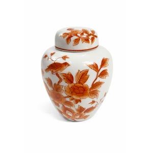 May include: A white ceramic ginger jar with a lid, adorned with orange floral and bird motifs. The jar has a rounded shape and is decorated with detailed illustrations of flowers and a perched bird. The lid mirrors the floral design.