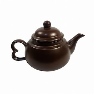 May include: A brown ceramic teapot with a lid and a heart-shaped handle. The teapot has a spout for pouring and a small knob on top of the lid. The teapot is a solid, dark brown color and is likely used for brewing tea.