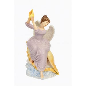 May include: A porcelain figurine of a woman with wings, holding a yellow object aloft. She wears a lavender dress and is seated on a seashell. The figurine has a serene expression and is set against a white background.