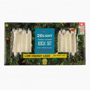 May include: A rectangular box featuring a 20-light icicle set for indoor/outdoor use. The box has a green background with a Christmas tree design. The text "20 LIGHT ICICLE SET" is visible on a blue label. Includes 2 spare bulbs.