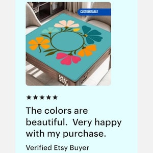 May include: A square table with a turquoise top featuring a floral design in pink, orange, and blue. The table has a dark wooden frame and is labeled "CUSTOMIZABLE".