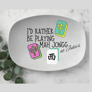 May include: A gray oval serving platter with the text "I'd rather be playing Mah Jongg at Julie's". The platter features colorful Mah Jongg tiles in pink, green, and white.