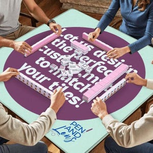 May include: A square mahjong table with a light green surface and a large purple circle in the center. The table has the text "Let us design the perfect to match your tiles!" in white. Pink mahjong tiles are arranged around the table.