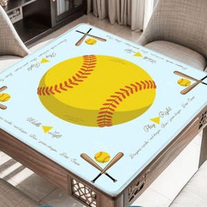 May include: A square table cover with a light blue background featuring a large yellow softball with red stitching. The design includes baseball bats, balls, and text that reads "Play Right" and "Walls Left".