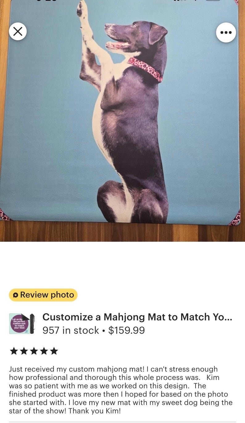 May include: Custom mahjong mat featuring a stylized dog illustration in a playful pose. The dog is primarily purple and white, set against a light blue background. The mat has a decorative border.