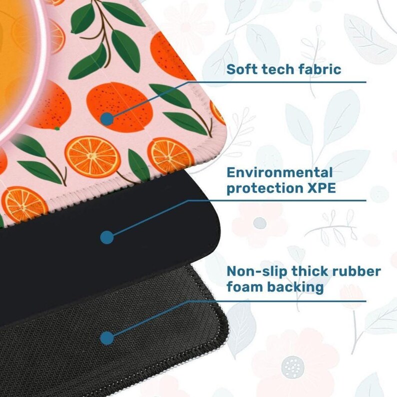 May include: A close-up of a mousepad with a pink surface featuring orange fruit and green leaves. The mousepad has three layers: soft tech fabric, environmental protection XPE, and non-slip thick rubber foam backing.