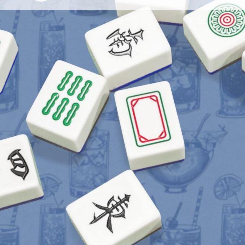May include: Close-up of several white Mahjong tiles with various symbols and markings in green, red, and black. The tiles are arranged on a blue background with a pattern of cocktail glasses.