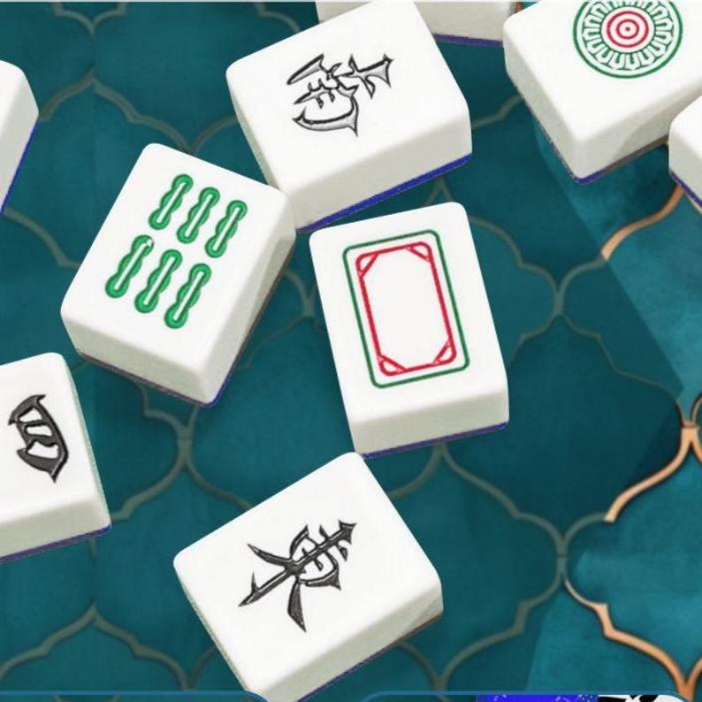 May include: A collection of white rectangular mahjong tiles featuring various black, green, and red engraved symbols. The tiles have a smooth finish and are scattered, displaying different characters, a green six-bamboo pattern, and a red frame.