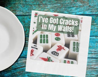 May include: A white square card with the text "I've Got Cracks in My Walls!" over a background of mahjong tiles. The tiles are white with green, red, and black symbols. A white plate is in the image.