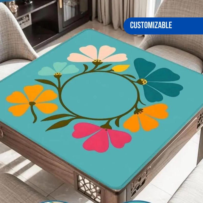 May include: A square table with a teal floral design. The design features colorful flowers in pink, orange, teal, and white, arranged around a central circle. The table is made of wood and has a decorative pattern on the sides. The word "CUSTOMIZABLE" is in a blue rectangle.