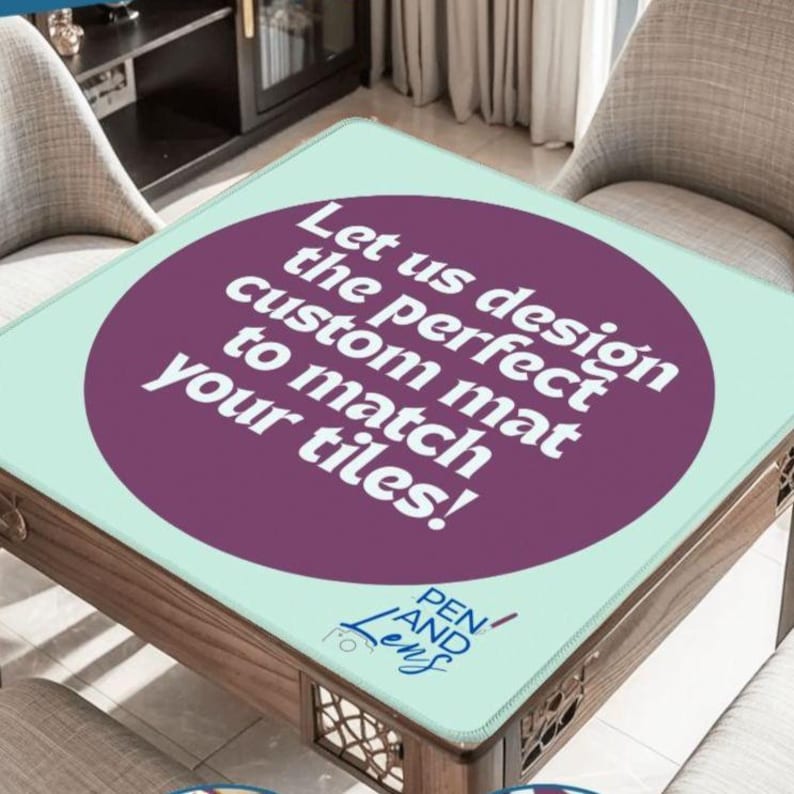 May include: A custom mat with a teal background and a large purple circle in the center. The text "Let us design the perfect custom mat to match your tiles!" is displayed. The mat is on a wooden table.