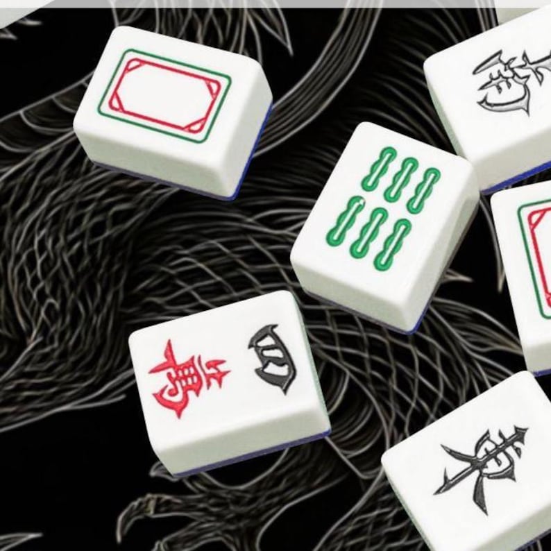 May include: White Mahjong tiles with various symbols in red, green, and black. The tiles have a rectangular shape with rounded edges and are set against a black background. The symbols include Chinese characters and geometric patterns.