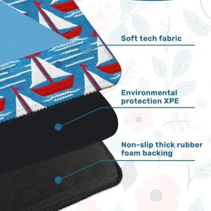 May include: A layered product with a blue top layer featuring red and white sailboats. The middle layer is black, and the bottom layer is a textured black. Text indicates "Soft tech fabric", "Environmental protection XPE", and "Non-slip thick rubber foam backing".