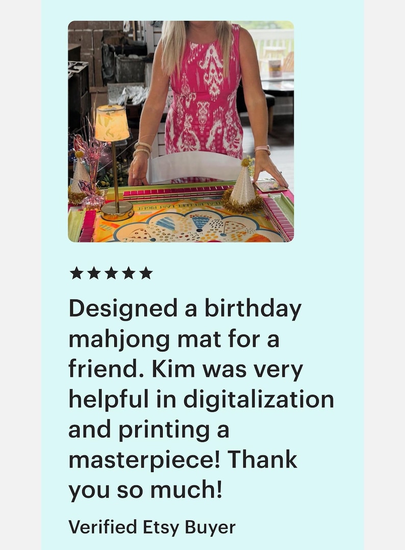 May include: A colorful mahjong mat with a birthday theme. The mat is on a table with a lamp and party hat. The text reads "Designed a birthday mahjong mat for a friend."