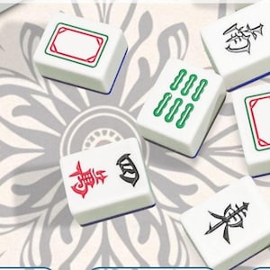 May include: White Mahjong tiles with green, red, and black symbols and markings. The tiles are arranged on a patterned background. Some tiles have rows of green markings, while others feature Chinese characters.
