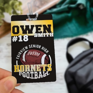 May include: Black and gold football player ID card with the name Owen Smith, number 18, and the text Fairview Senior High Hornets Football.