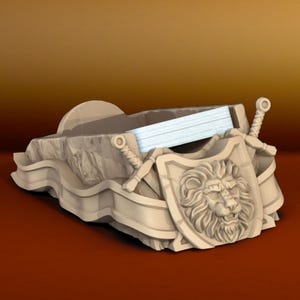 May include: A decorative, beige-colored, lion-shaped, paperweight with a shield and crossed swords. The paperweight is made of a stone-like material and has a textured surface.