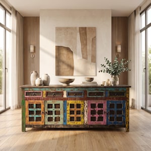 May include: A long wooden sideboard featuring a distressed, multi-colored finish with shades of blue, yellow, green, and pink. It includes five upper drawers and five lower cabinet doors with grid-patterned panels and dark metal hardware pulls.