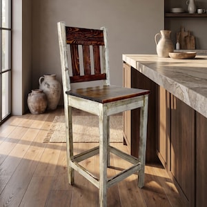May include: A tall wooden bar stool featuring a distressed white painted frame and a dark brown stained seat and backrest. The backrest has three vertical slats, and the stool includes four legs connected by horizontal support bars on all sides.
