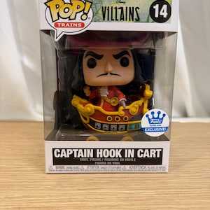 May include: Funko Pop! vinyl figure of Captain Hook in a cart from the Disney Villains series. The figure is in a clear plastic display case. The box has the Funko Pop! and Disney Villains logos, and the text "Captain Hook in Cart."