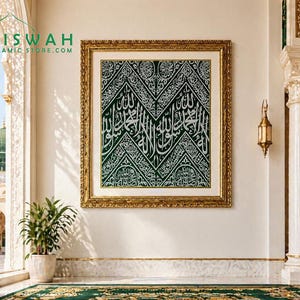 May include: A framed artwork featuring Arabic calligraphy in white on a dark green background. The frame is gold-colored, and the artwork hangs on a white wall. The image includes a view of a mosque and the text "KISWAH ISLAMIC STORE.COM".