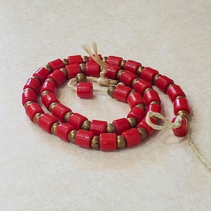 Vintage red glass tube beads for necklaces or bracelet with small round brass beads in-between. Small amount old stock beads.