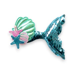 May include: A turquoise mermaid tail hair clip with a green iridescent seashell and pink and blue starfish accents.
