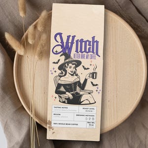 May include: A tan coffee bag with a vintage witch illustration. The bag features the text "Witch, Better Have My Coffee." The illustration depicts a woman in a witch hat holding a coffee cup. The bag is labeled "100% Whole Bean Coffee" and weighs 12 oz.