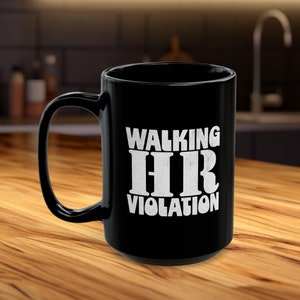 May include: Black coffee mug with white text that reads "Walking HR Violation".