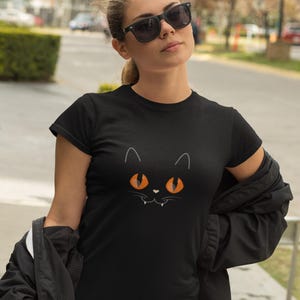Halloween Black Cat T-Shirt - Spooky Cat Face with Orange Eyes - Cute and Creepy Unisex Tee for Halloween Fans