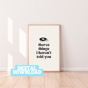 May include: A printable digital download of a black and white illustration of a record player with the text "theres things i haven't told you" in bold black font.