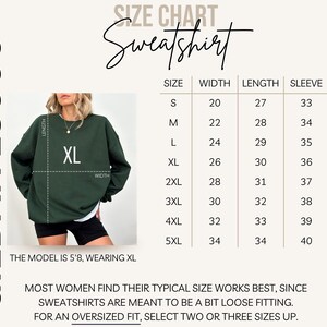 May include: A dark green Gildan 18000 sweatshirt with an XL size label. The image includes a size chart with measurements in inches for width, length, and sleeve length. The model is 5'8" and wearing an XL. Text on the image advises on sizing.