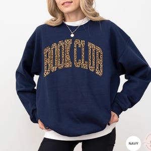 May include: Navy blue sweatshirt with a leopard print "Book Club" graphic.