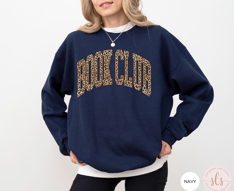 May include: Navy blue sweatshirt with a leopard print "Book Club" graphic.
