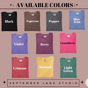 May include: A display of folded t-shirts in various colors, including black, espresso, pepper, blue jean, violet, berry, crunchberry, crimson, mustard, and light green. The text "AVAILABLE COLORS" is at the top, with "SEPTEMBER LANE STUDIO" at the bottom.
