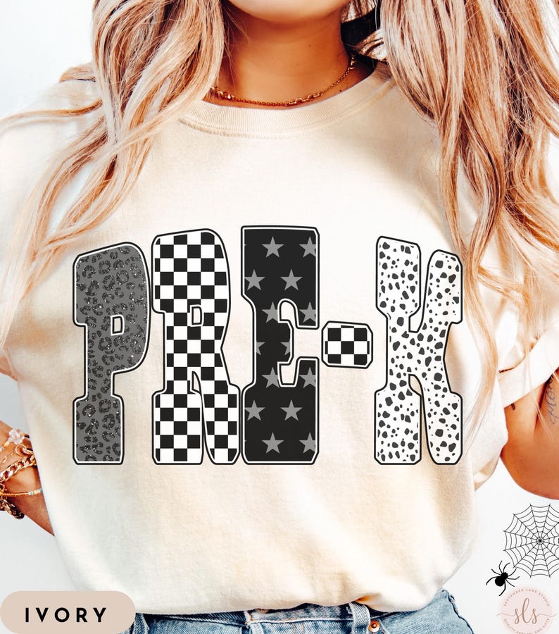 May include: Ivory-colored sweatshirt featuring the word "PRE-K" in a bold, decorative font. The letters have unique patterns: leopard print, checkered, star-filled, and dalmatian spots. The word "IVORY" is printed at the bottom.