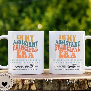 May include: Two white ceramic mugs with a colorful retro design that says "In My Assistant Principal Era" with the text "Guiding with Strength Leading with Heart" and the name "mrs. smith" and the text "Eastside Elementary School".