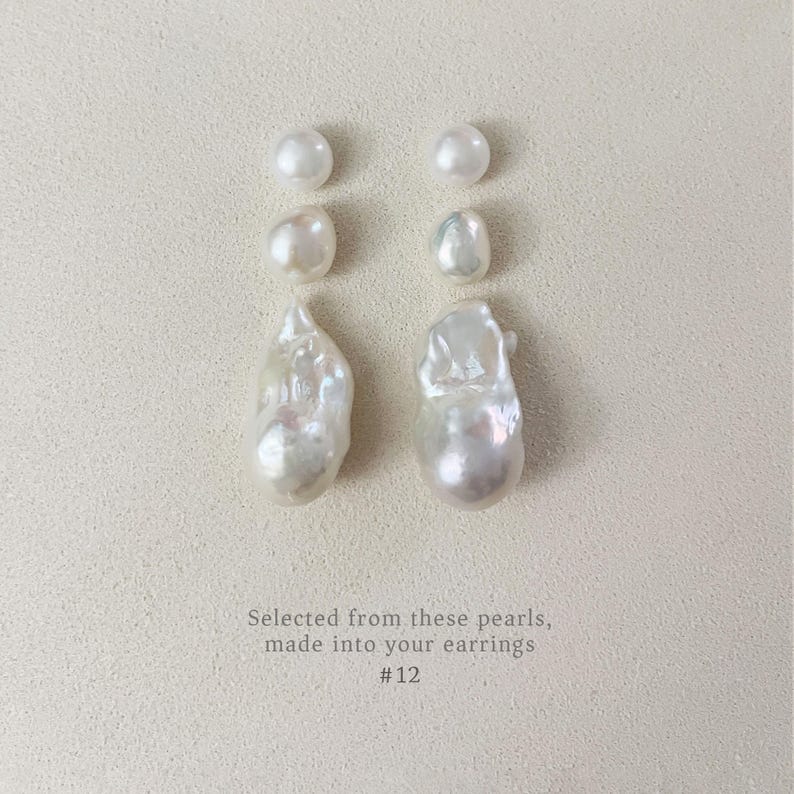 May include: Four white pearls and two pairs of white baroque pearl earrings are displayed on a textured, off-white surface. The text reads: "Selected from these pearls, made into your earrings #12."