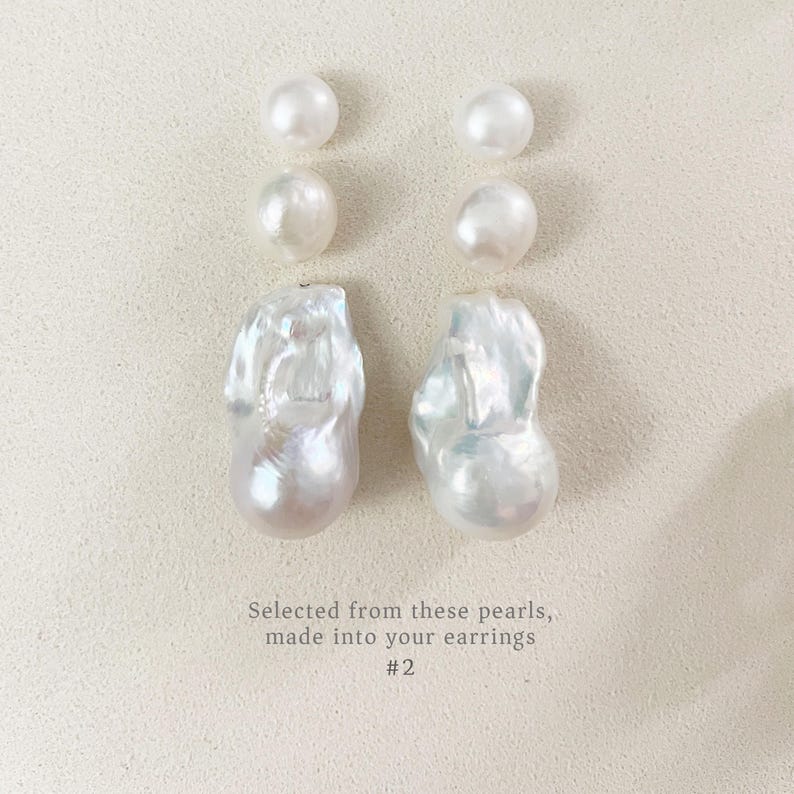 May include: A selection of white pearls, comprising four small, round pearls and two large, uniquely shaped pearls. The pearls are displayed on a light-toned surface. Text on the image reads: "Selected from these pearls, made into your earrings #2."