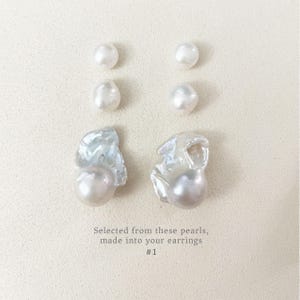 May include: An arrangement of white pearls, including round and baroque shapes, displayed on a neutral surface. The image includes the text: "Selected from these pearls, made into your earrings #1."