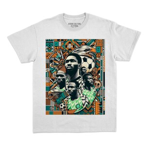 May include: White t-shirt featuring a vibrant graphic design. The design includes portraits of soccer players, eagles, and a soccer ball, set against a colorful geometric pattern. The text "AFRIK CULTURE CLOTHING" is printed on the collar.