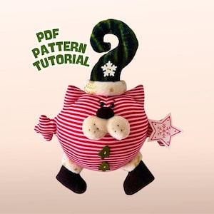 Puede incluir: Una muñeca de elfo navideño caprichosa con un cuerpo a rayas rojas y blancas, un sombrero verde con un copo de nieve y un adorno en forma de estrella. El texto "PDF PATTERN TUTORIAL" es visible.
