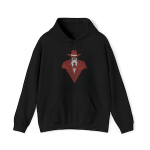 May include: A black hooded sweatshirt featuring a central graphic print of a character wearing a red wide-brimmed hat, a red trench coat, a white collared shirt, and a red necktie. The hoodie includes a front kangaroo pocket and long sleeves.